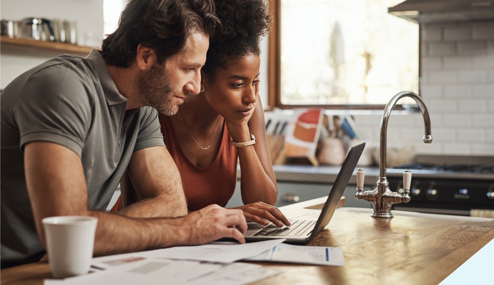 Couple reviewing property details on a laptop at home