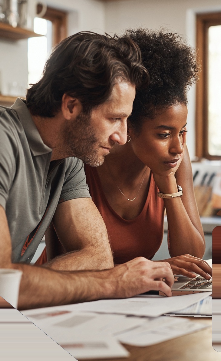 Couple reviewing homeownership costs at home