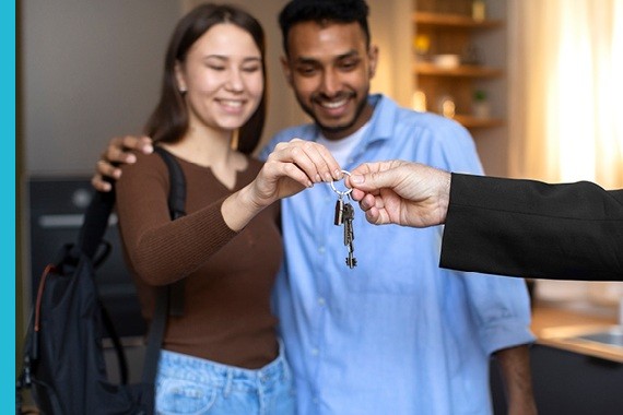 Couple receiving keys inside a rental home